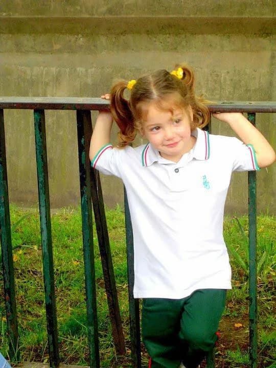 Pili as a child in her school uniform.