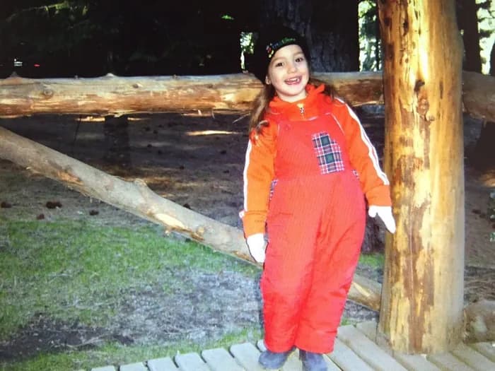 Pili as a child in a snow suit.