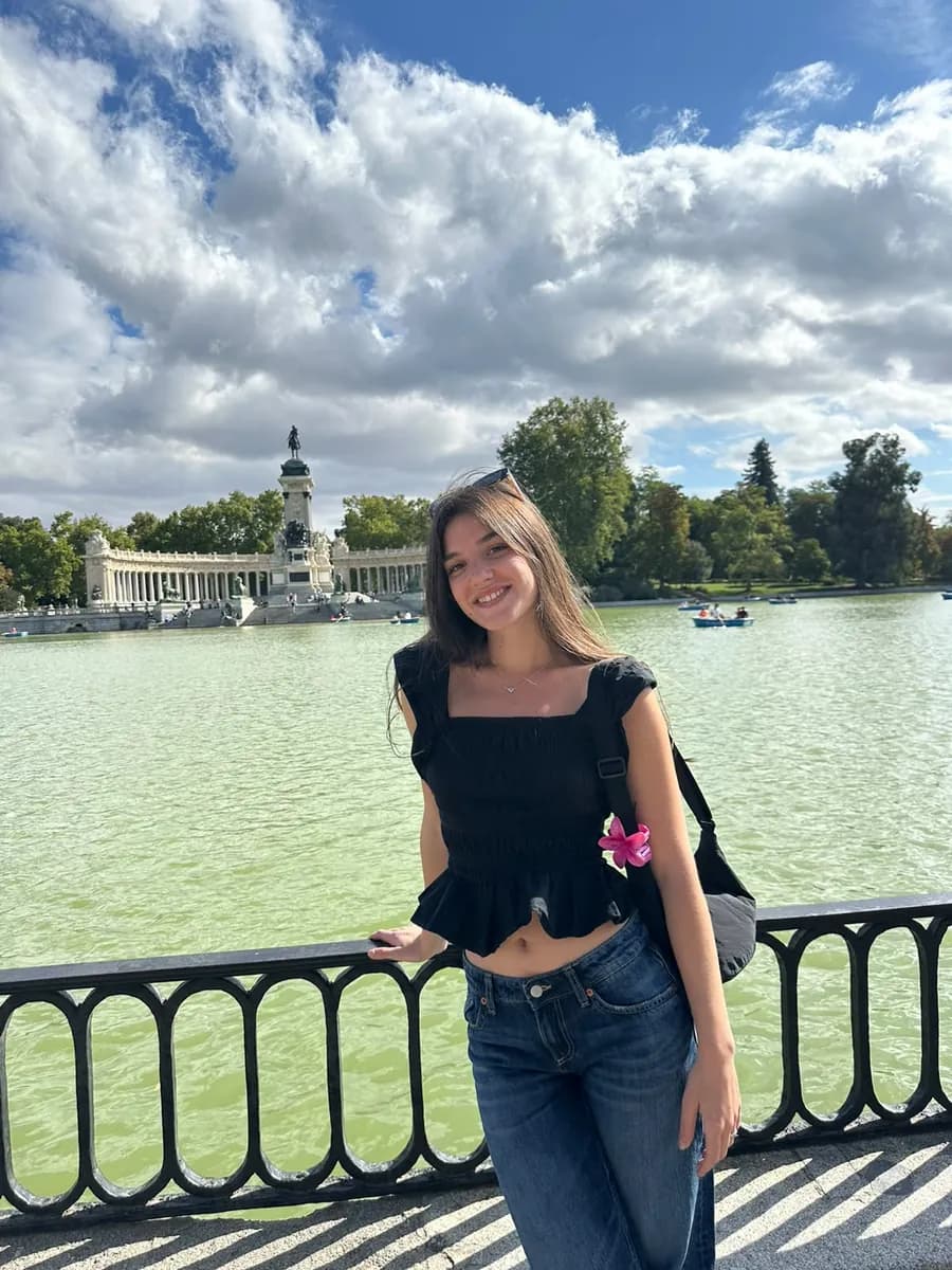 Pili smiling by the lake in Retiro Park, Madrid.